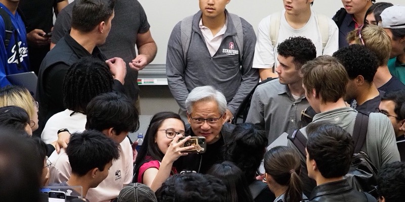 Jensen Huang posing for a selfie with a crowd of Stanford students