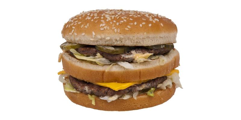 A McDonald’s Big Mac burger with a sesame seed bun, two beef patties, cheese, lettuce and pickles, on a white background
