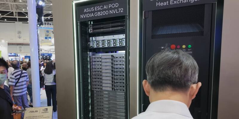 Visitors look at a tall black Asus ESC AI Pod server rack labelled Nvidia GB200 NVL72 at a trade show