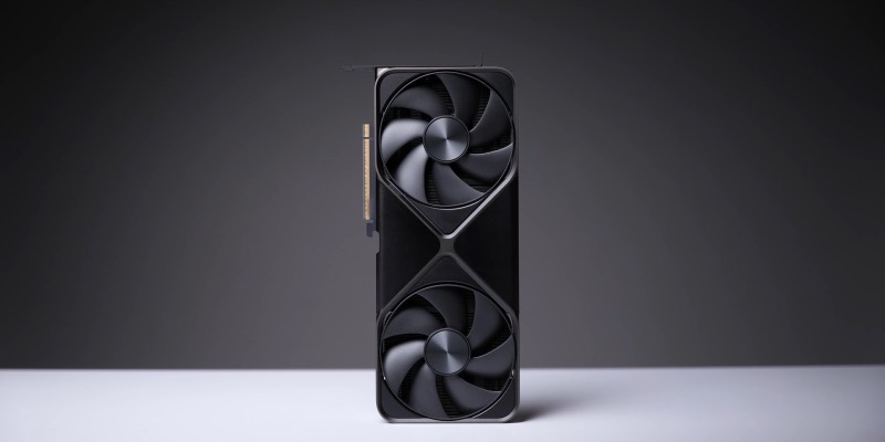 A black Nvidia GeForce RTX 5090 graphics card with two large fans, standing upright on a white surface against a dark grey background